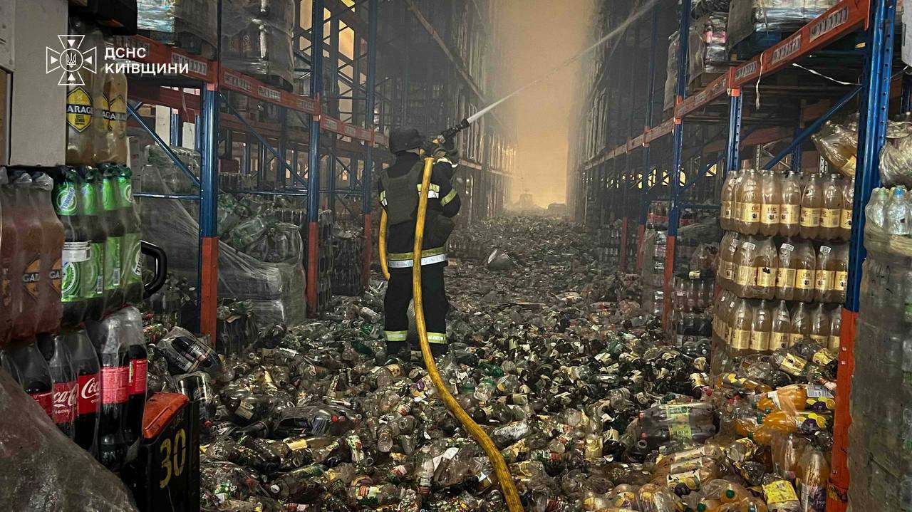 A firefighter battles a warehouse fire following a Russian strike on Ukrainian food storage